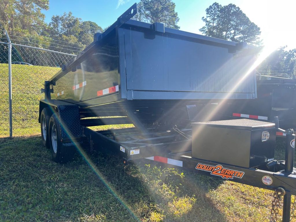 Down 2 Earth 6 foot x 12 foot 10K dump trailer with dual 5,200 lb axles, slide-in ramps, LED lighting, powder-coated tongue box, and heavy-duty 10ga floor