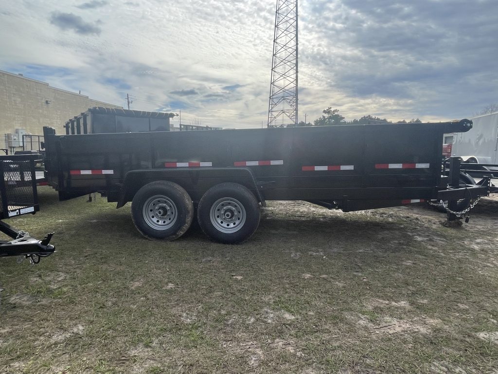 Down 2 Earth 7 foot x 16 foot dump trailer with 2ft sides, dual 7,000 lb axles, slide-in ramps, powder-coated tongue box, D-ring tie downs, and LED lighting
